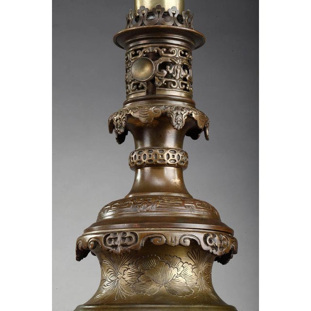 Pair of french antique kerosene lamps. The bronze paunch is decorated with birds on branches and flowers in chinese style....
