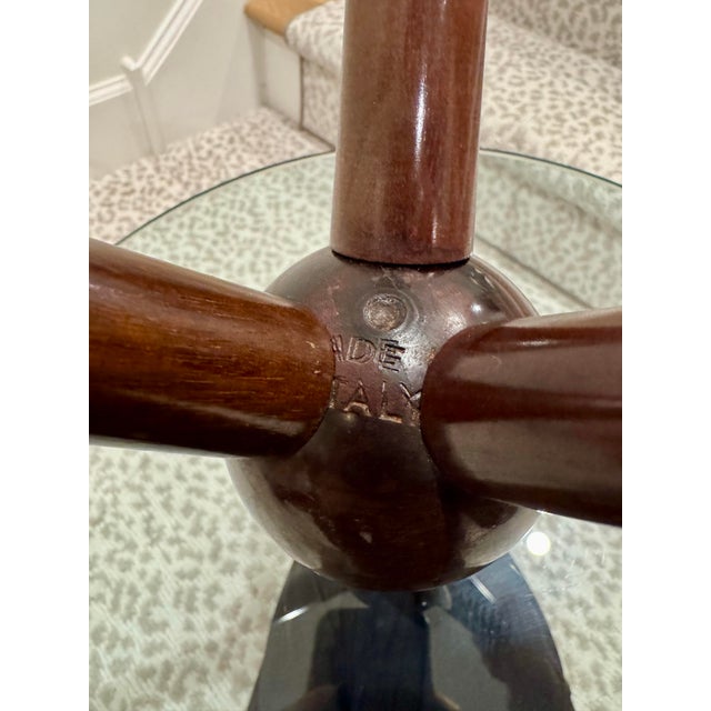 Elegant and practical easy-to-move table with turned wooden structure and thick glass top, blocked by the central stem...