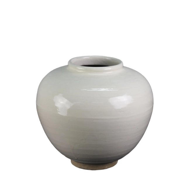This white pear jar is a handmade porcelain pottery vase with its natural variance. The jar is an elegant off-white color,...