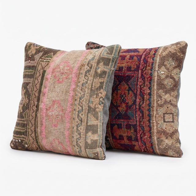 This 20'' x 20'' pillow cover set was made from authentic Turkish rug pieces — faded pink medallion stripe beside plum...