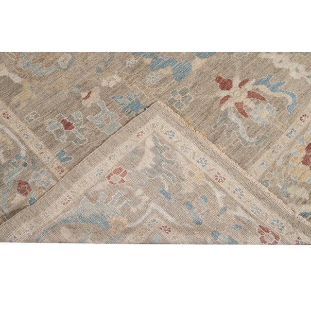 Beautiful Modern Sultanabad hand-knotted wool rug with a tan field. This Sultanabad rug has a multi-color accent in a...