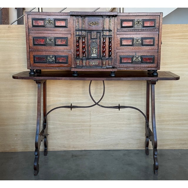 This elegant antique Bargueño or Vargueño desk was crafted in Spain circa 1820. The two-piece cabinet-on-stand features a...