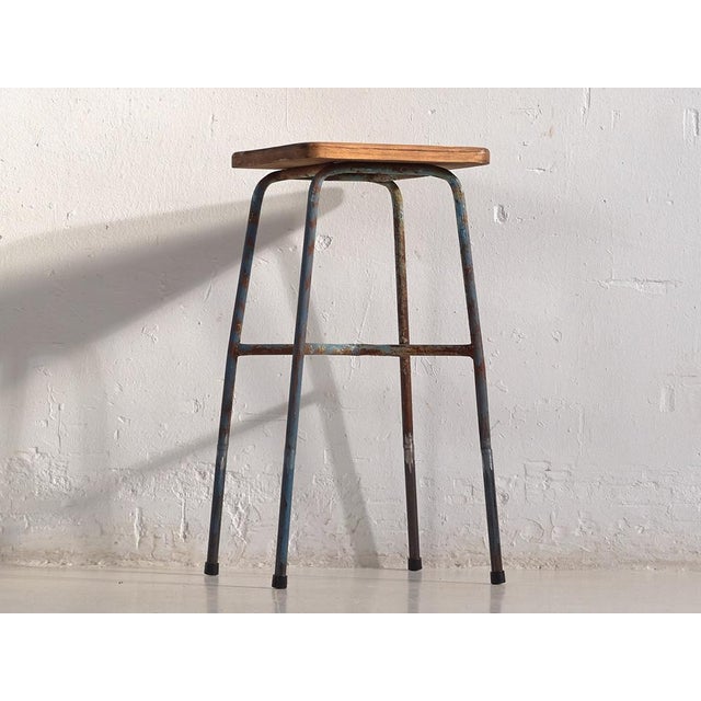 Vintage metal industrial style stool with metal legs and a 70cm high solid wood seat (France, c.1950). We recovered...