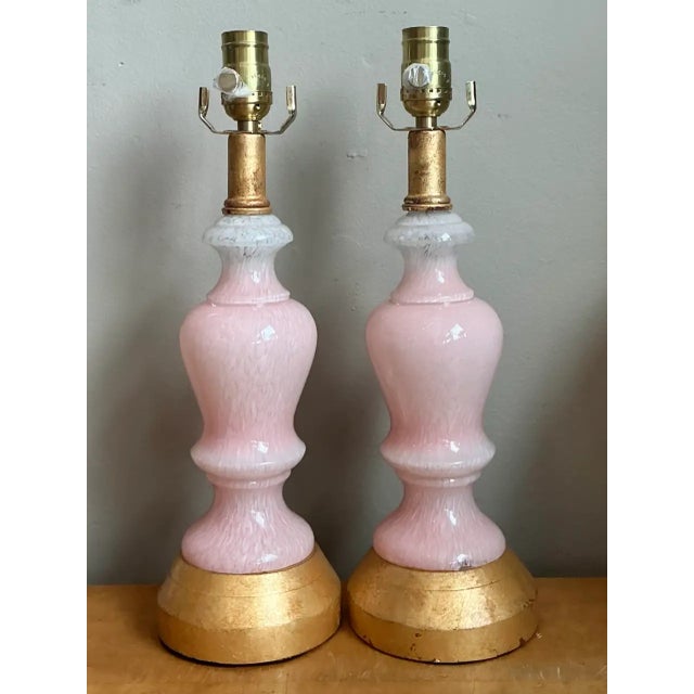 These vintage Murano table lamps pair softly opalescent pink blown-glass bodies with warm, circular wood bases and brass...