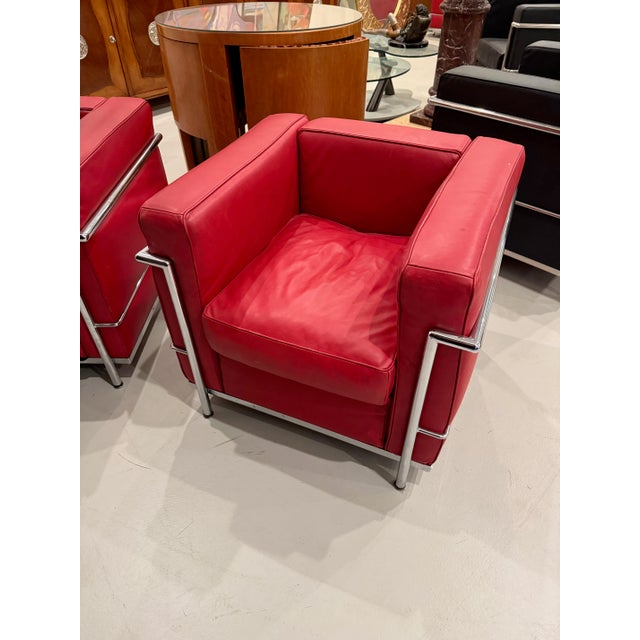 Stylish pair of chrome and red leather club chair in the style of Le Corbusier.