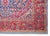 A striking early 20th century Persian Kashan rug with a central medallion living amidst a field of tightly woven flowers...