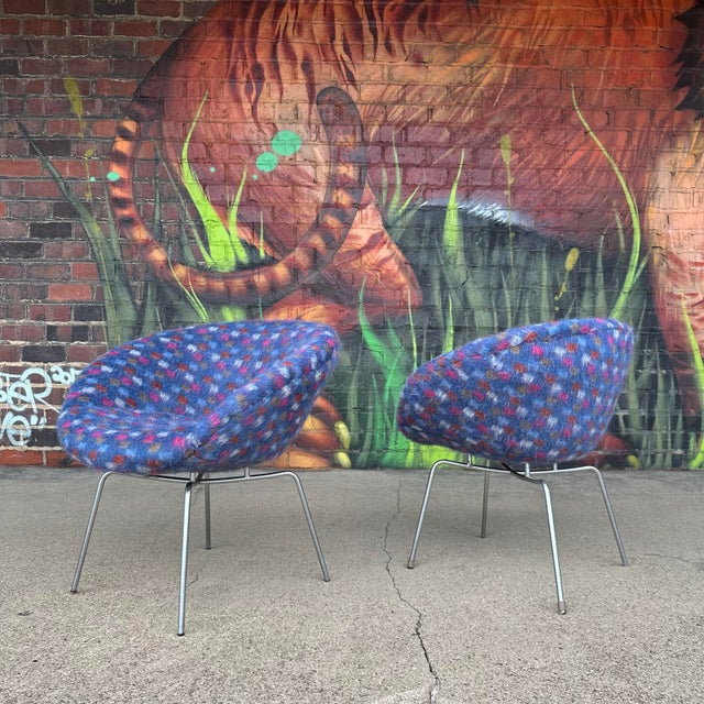 Pair of pot chairs by Arne Jacobsen. These chairs sit upon a chrome base and have been recently recovered in Knoll...