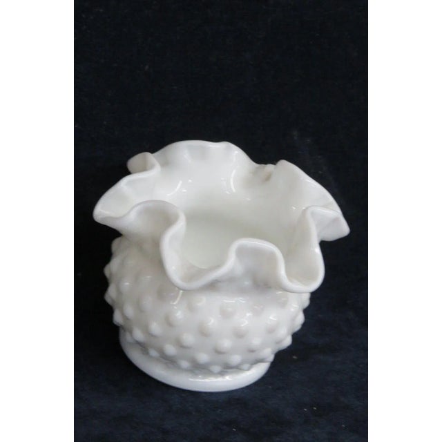 This wonderful small vase is made of milk glass. This piece is made in the Hobnail pattern used by Fenton, it features a...