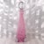 This is a pink and white cased in clear tall perfume bottle with a clear stopper. It has no markings or tags. It is...