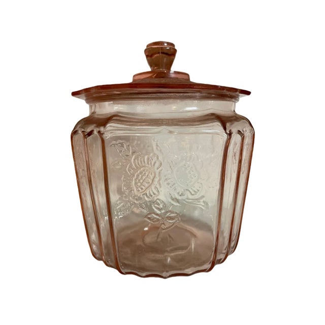 1930s depression pink glass cookie jar features a unique cabbage motif, delightful representation of the era’s glassware...