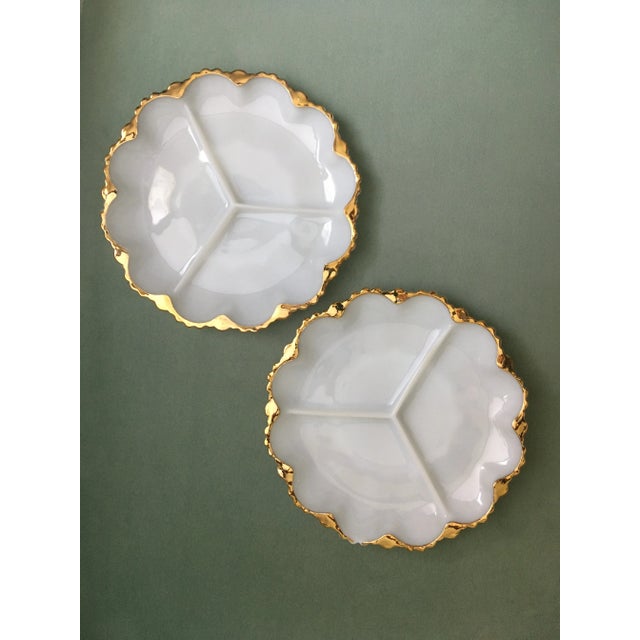 A beautiful trio of milk glass gilt edged serving plates with two divided into sections of three and one with twelve...