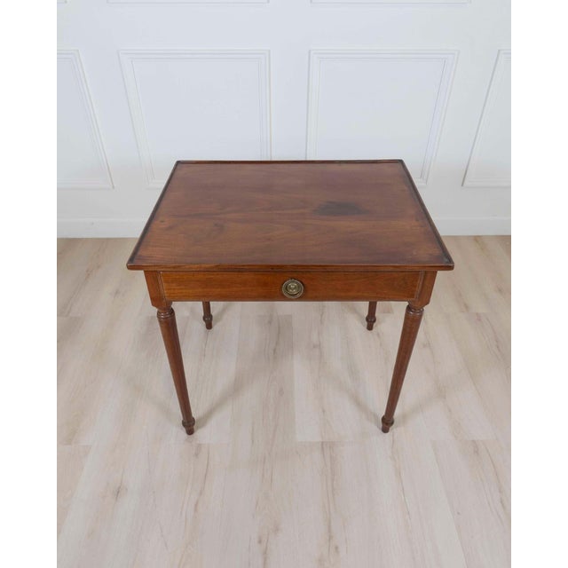 A refined Italian late 18th century Neoclassical walnut desk, distinguished by its elegant proportions and understated...