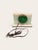 A mid-century electric mantel clock cut from white onyx, its soft veining lifted by vertical brass inlay and a round gold-...