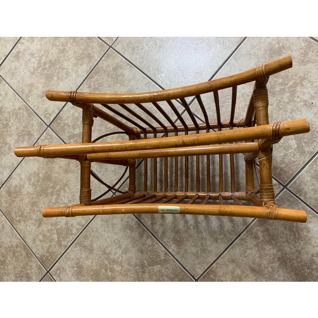 Vintage rattan magazine rack with a double-compartment design. This piece is constructed from natural honey-toned rattan...