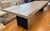 A striking Restoration Hardware dining table that pairs an expansive, character-rich wood top with sculptural black metal...