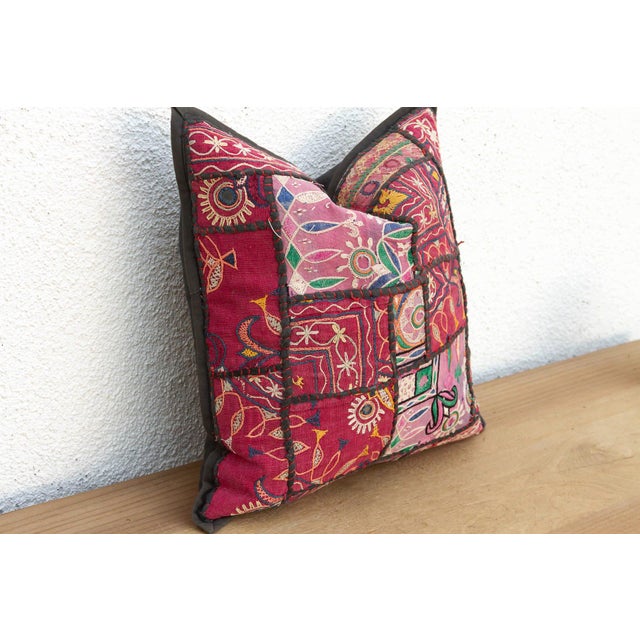 This 17-inch square pillow is a breathtaking fragment of Rajasthani heritage, repurposed from antique Banjara textiles...