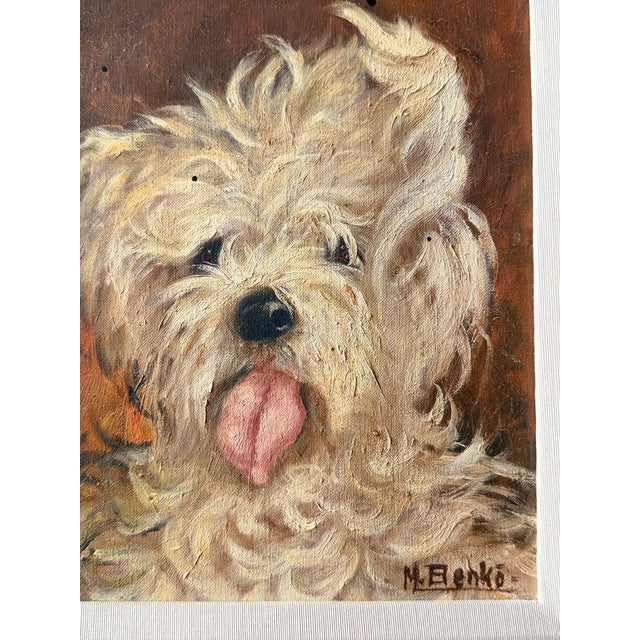 A charming and finely executed antique dog portrait, rendered in oil on canvas and depicting a fluffy, light-toned dog...