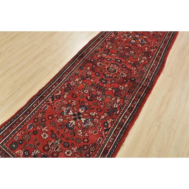 An authentic vintage traditional Malayer runner hand-knotted with fine wool and natural dyes. This rug features an all-...