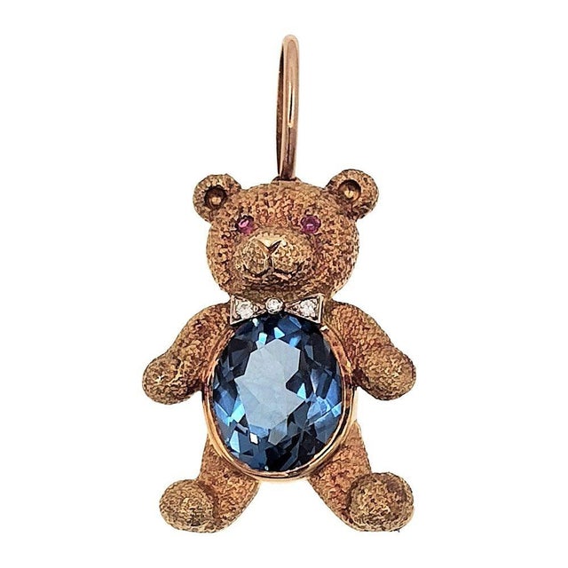 Estate 18K gold blue topaz teddy bear pin or pendant. This textured teddy bear pin or pendant is crafted in 18 karat...
