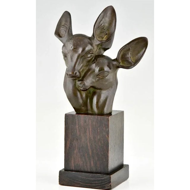 Art Deco bronze bust of two deer signed by Georges H. Laurent. Green patinated bronze on a wooden base. France, 1930. This...