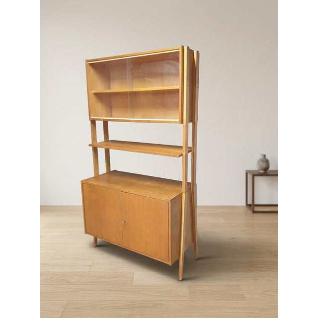 Elegant mid-century wall shelf bookcase designed by František Jirák for Tatra nábytok during the 1960s. The piece combines...
