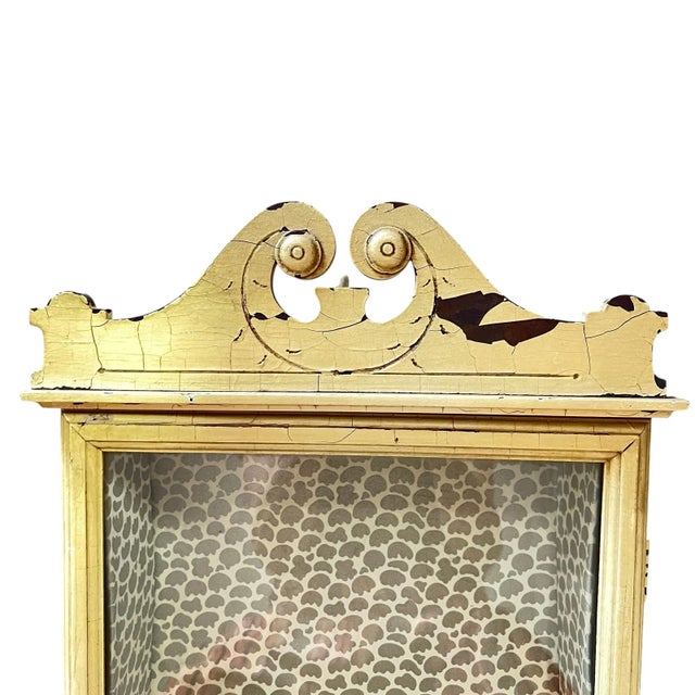 This charming 1940s wooden wall-mounted curio cabinet features a glass door and an interior shelf, perfect for displaying...