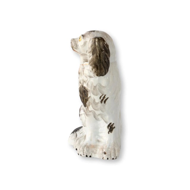 Mid-19th century Staffordshire spaniel with muted black-and-white coloring and those unforgettable golden-yellow eyes....