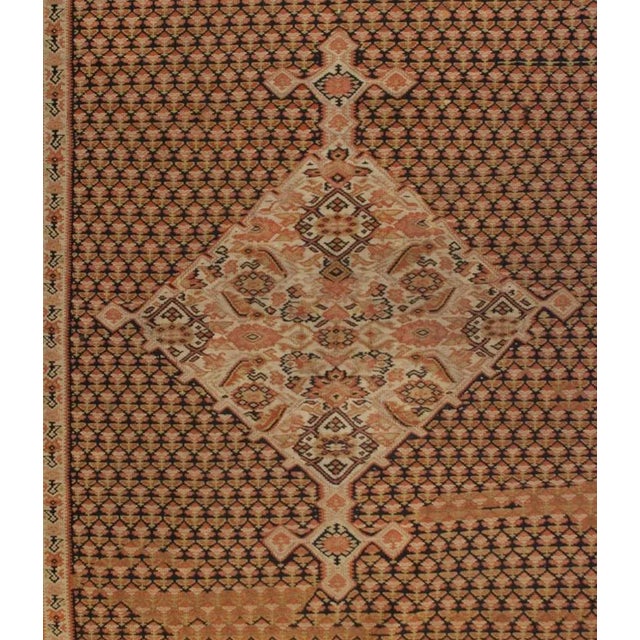 A gorgeous early 20th Century Persian camel hair Senneh Kilim rug with a wonderful diamond medallion on a field of...
