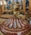 This elegant French-style porcelain covered vase features a rich burgundy finish accented with intricate gold leaf...