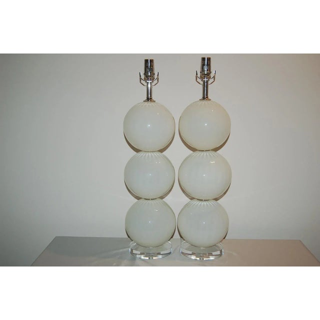 Matched pair of hand blown three ball glass table lamps by Joe Cariati in OYSTER WHITE, a transluscent color that has an...