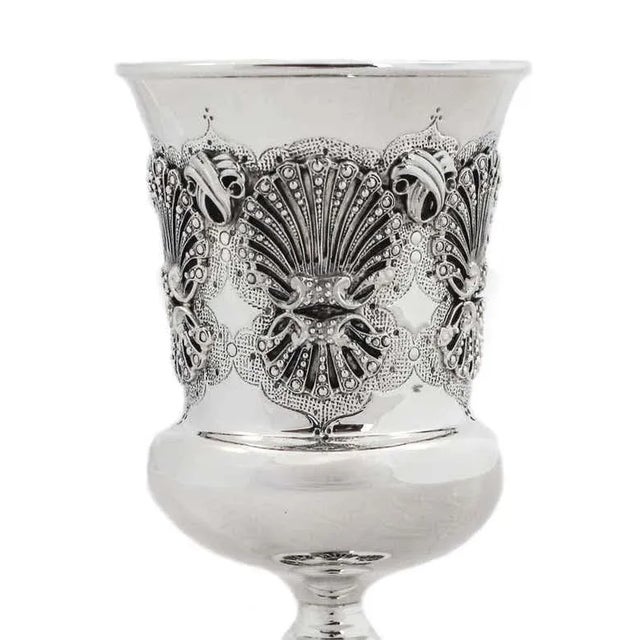A beautiful sterling silver Kiddush cup (goblet) is being offered. The workmanship around the center and base is gorgeous!...