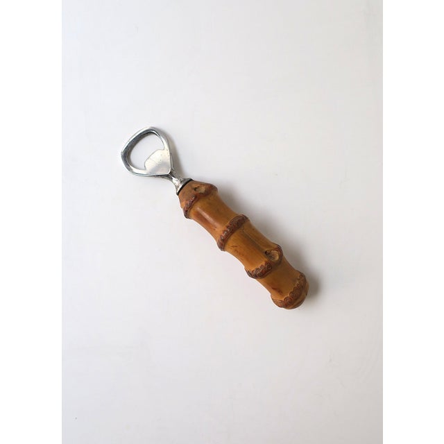 An English Sheffield stainless steel bottle opener with a natural bamboo handle, in the Campaign design style, circa mid‑...