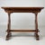 A charming early 20th-century English coffee table in the Arts and Crafts tradition, finely crafted from golden oak and...