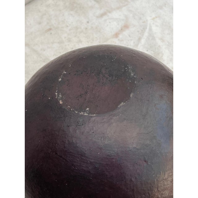 The early 20th-century South African clay beer pot from the Zulu culture is a spherical beer pot showcasing faintly...