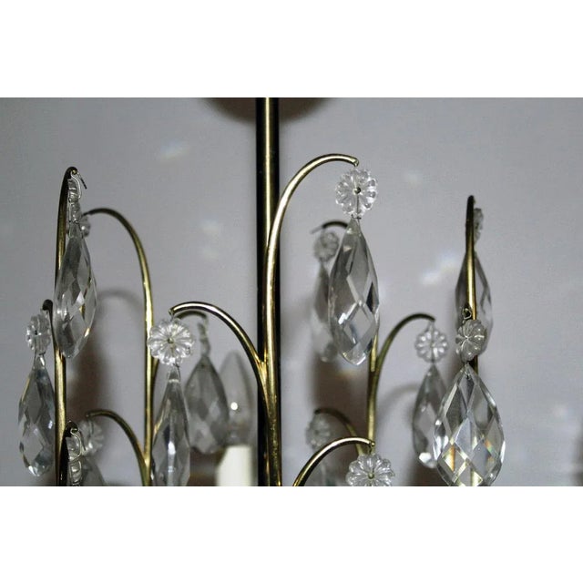 This five-armed brass chandelier features original sockets and crystal elements. I have official proof of authenticity...