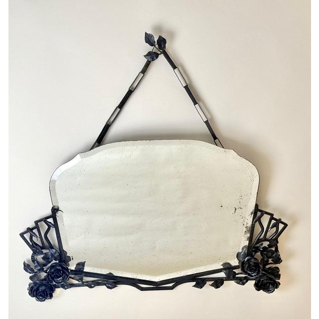 This exceptional French wrought iron mirror, created circa 1935–1945, is a remarkable example of artistic blacksmithing at...