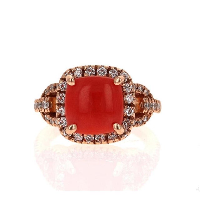 This one of a kind beauty has a magnificent 3.22 Carat Cushion Cut Coral and is further embellished with 42 Round Cut...