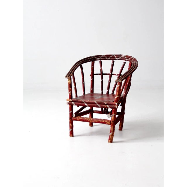 This is an antique children's folk art chair. A rustic hand-crafted chair with bentwood twig frame, wearing its original...