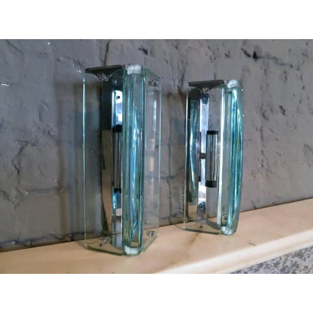 A smart pair of sconces in the manner of Fontana Arte, with chrome fitting and thick cut curved glass diffusers. Up to...