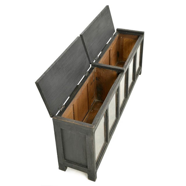with its glass front and black patinated wood, this low chest seduces with its industrial character and discreet...