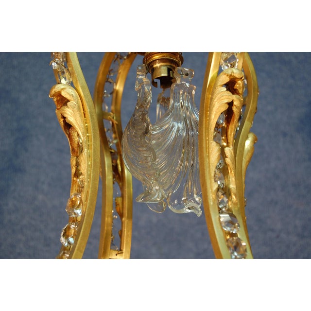 This important and elegant antique chandelier was produced in the late nineteenth century. It has a finely chiseled bronze...