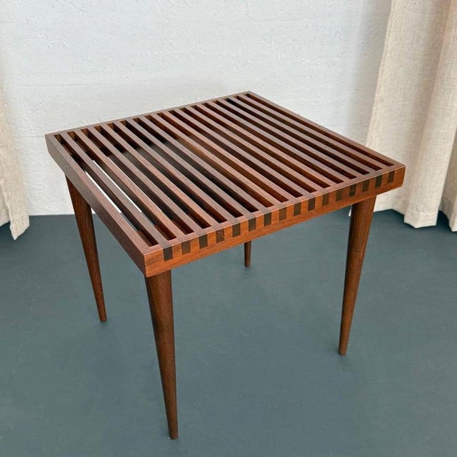 This petite walnut side table is designed by American designer Mel Smilow circa 1950s. The table perfectly captures...