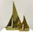 A graduated pair of vintage brass sailboat sculptures featuring simplified geometric sails and gently curved hulls. Their...
