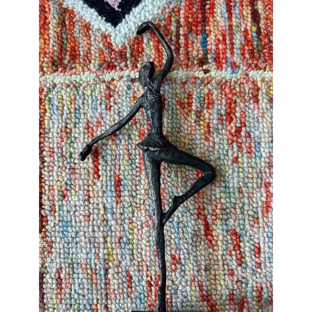 Elegant cast-bronze ballerina sculpture capturing a moment of perfect balance and poise. The elongated limbs, simplified...