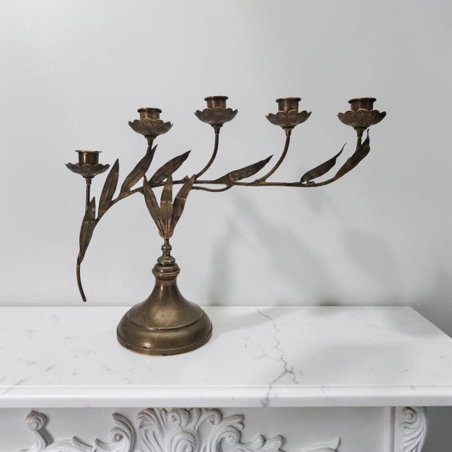 An elegant French brass candelabra executed in the sinuous botanical language of the Art Nouveau period. The sculptural...