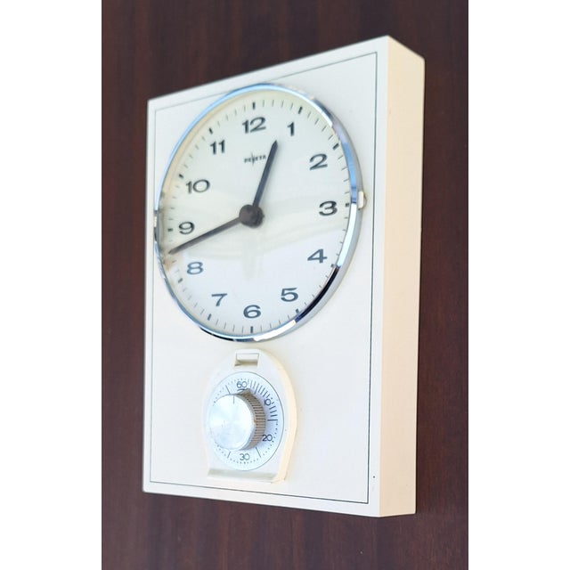 Mid-Century German Wall Clock with Integrated Egg Timer from Deweta, 1960s, in Very Good conditions. Designed 1960 to 1969...