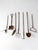 A collected assortment of antique and early 20th century kitchen garden tools with weathered wood handles and aged iron...