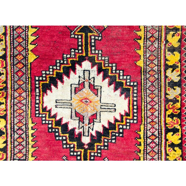 A bold and brilliant early 20th century Turkish Konya rug with a tribal pattern containing a central geometric medallion...