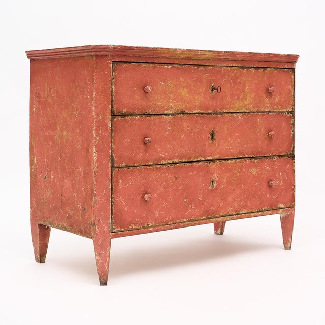 This fabulous Italian chest features the original salmon colored paint and a wonderful patina. The paint has wear...