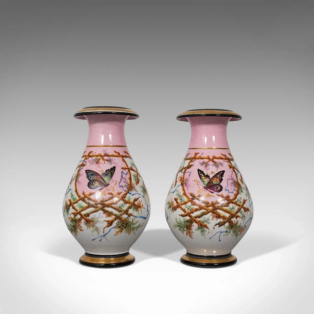 This is an antique pair of peony vases. A French, decorative ceramic baluster urn adorned with butterflies, dating to the...